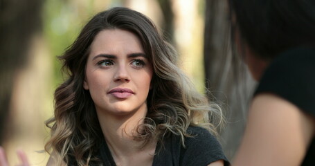 Obraz premium Candid friend listening to conversation outside at the park