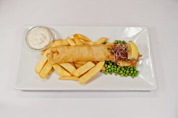 View on white background of french fries with green peas. Healthy food, diet lunch concept.