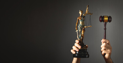 Lawyer or judge holding gavel and lady justice statue. Law and justice