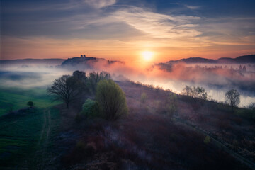 A monastery in Tyniec during the foggy sunrise. This Benedictine abbey is located close to Kraków city in Poland. - obrazy, fototapety, plakaty