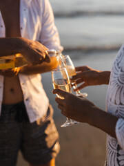 honeymoon couple drinking champagne on tropical beach