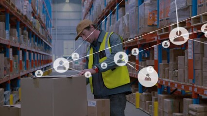 Animation of networks of connection with people icons over caucasian man working in warehouse