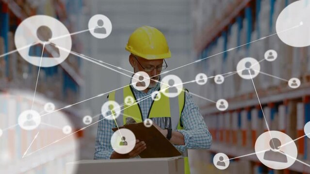 Animation of networks of connection with people icons over caucasian man working in warehouse