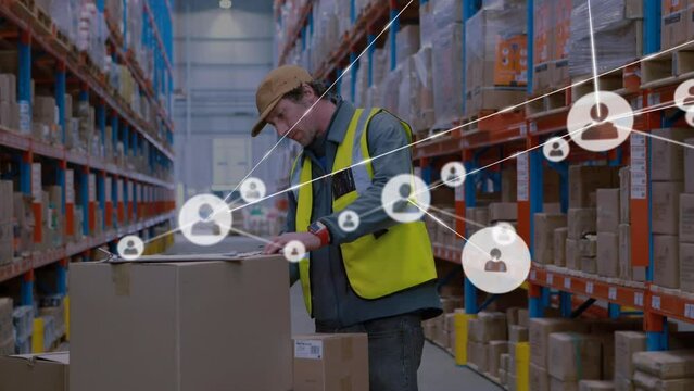Animation of networks of connection with people icons over caucasian man working in warehouse