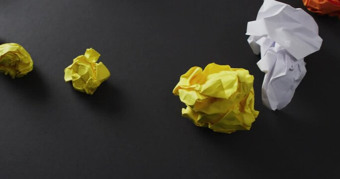 Video of colorful paper balls and yellow plane on black background