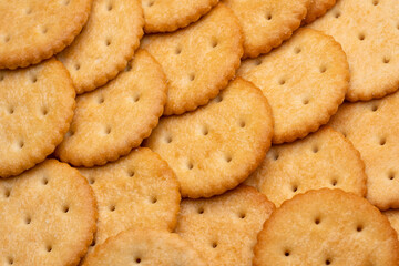 Healthy whole wheat cracker on white background. Stack of Saltine crackers isolated on white background. Round crackers.