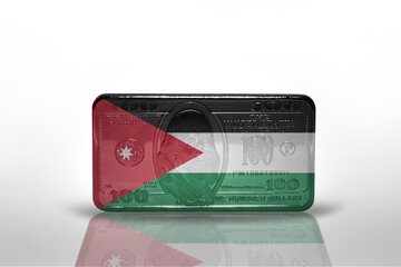 national flag of jordan on the dollar money banknote on the white background .