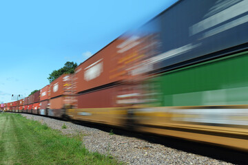Blurred freight train of container cars in motion