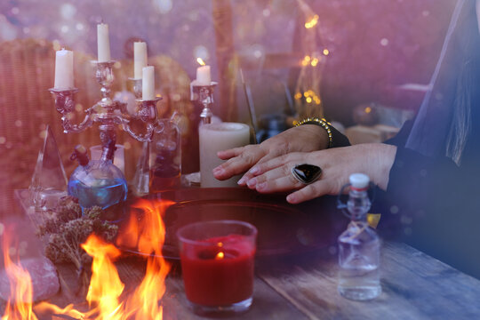 seance in salon of soothsayer, fortune tellers, close-up female hands of psychic doing witchcraft passes, concept of Halloween theme, black magic, conspiracies for good luck, happiness, money