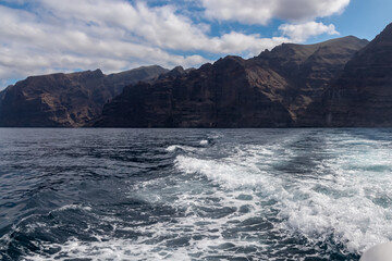 Fototapeta na wymiar Panoramic view on the massive cliffs of Los Gigantes in Santiago del Teide, Western coast of Tenerife, Canary Islands, Spain, Europe. Rock formations along the coastline of the Atlantic Ocean. Freedom