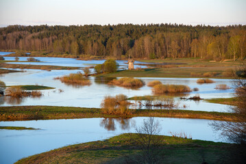 The spring flood of the Sorot River in the sunset light. Mikhailovskoye, Pskov region. Russia
