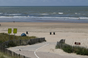 View on the beach. The text on the yellow signs are translating each other, one in Dutch, the other...