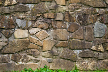 high stone fence made of large stones