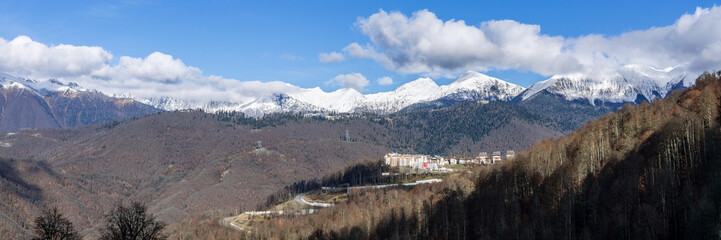 Peaks of a mountain range with cumulus clouds in Krasnaya Polyana