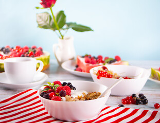 Granola, muesli cereals with yogurt or milk and fresh berries. Healthy breakfast concept.