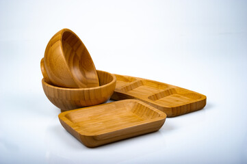 Wooden bowl and food presentation material shot on white background in photo studio.