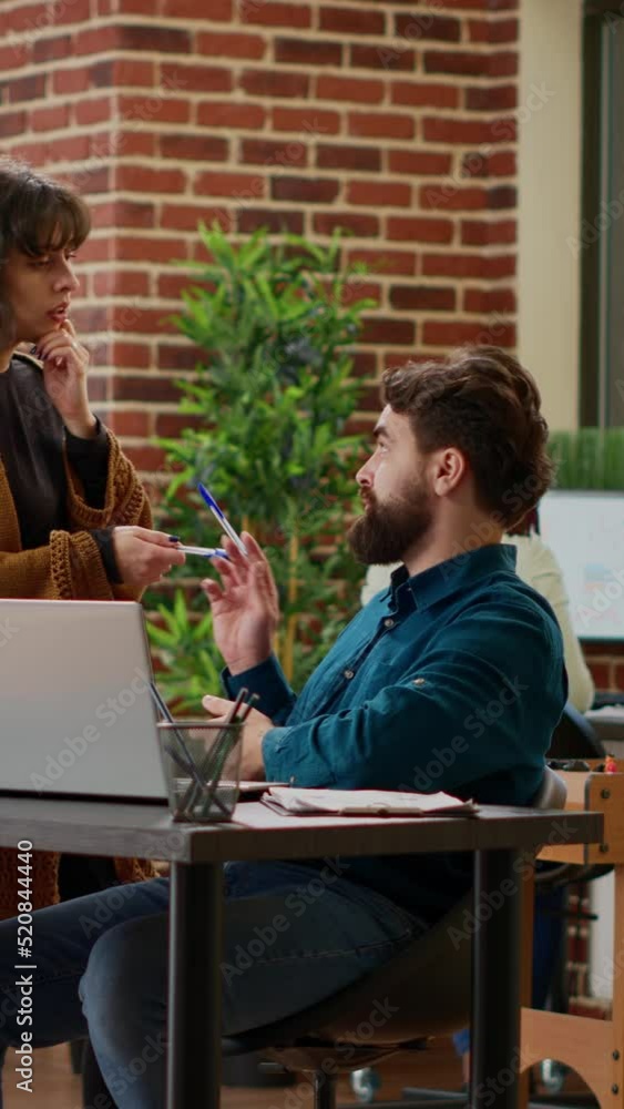 Poster vertical video: man and woman doing teamwork on business project plan, analyzing charts information 