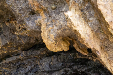 rocks near the beach with a great variety of veins of different colors and minerals, live and natural colored rocks