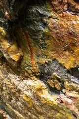 rocks near the beach with a great variety of veins of different colors and minerals, live and natural colored rocks