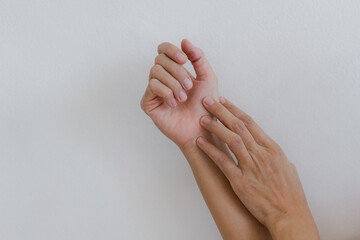 Closeup of hand with hand pain in palm isolated on gray wall background.