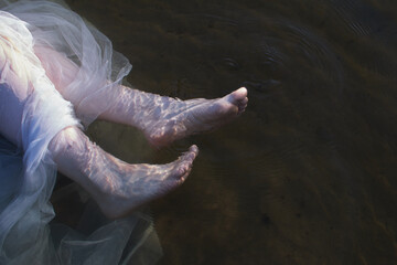 woman legs in the water, creative photo