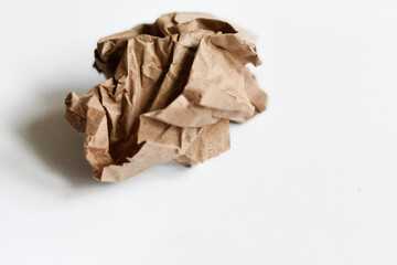 Crumbled brown paper on white background