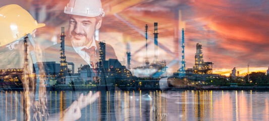 Double exposure of Caucasian engineer mechanic man standing at factory with blur refinery plant...