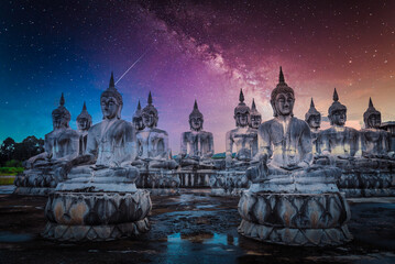 Milky way over many Statue buddha image at night in southen of Thailand.