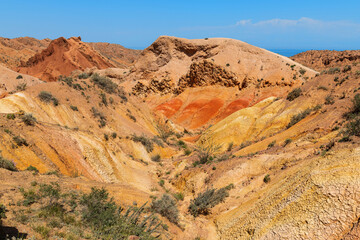 A picturesque gorge with multi-colored clay on the southern shore of the Kyrgyz lake Issyk Kul