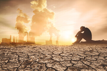 Concept of global warming and drought. People are sitting in despair because of the drought. a...