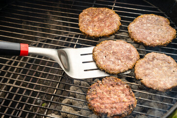 Selective focus of fresh delicious burger cutlets grilling on bbq grill