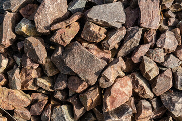 Brown rubble texture. Gravel pebbles stone background. Brown small rocks ground.