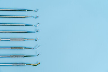 Dentist tool set. Teethcare, dental health concept. Blue background top view copy space