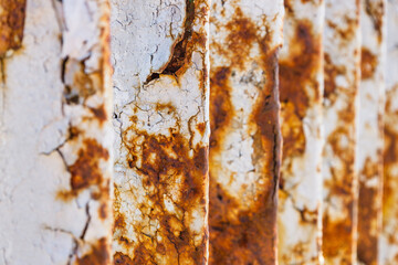 Fototapeta premium Rusty bridge railing texture background with cracked white paint