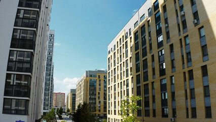 Obraz premium Contemporary residential buildings in the city. Stock footage. Exterior of a modern design of multistorey apartment buildings, aerial view.