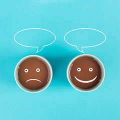 Cup of coffee with a sad and a happy face, positive and negative mindset, support and evaluation concept, speech bubble