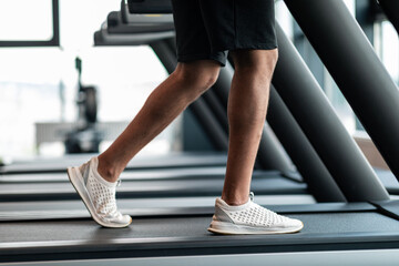 Jogging Workout. Cropped Shot Of Black Male Training On Treadmil At Gym