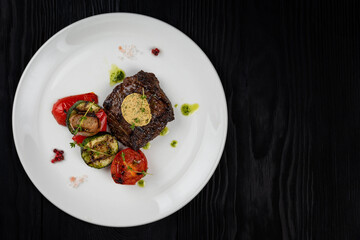 Grilled black angus strip loin steak with vegetables
