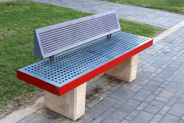 Bench for rest in the city park on the seashore.