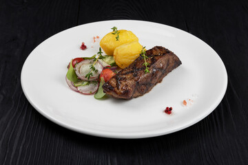 Grilled black angus strip loin steak with vegetables