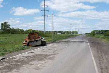 A burnt Russian tank near a residential building. War in Ukraine 2022. Russian missiles in Kharkiv countryside Ukraine. Russian aggression. Russian attack on Ukraine. 