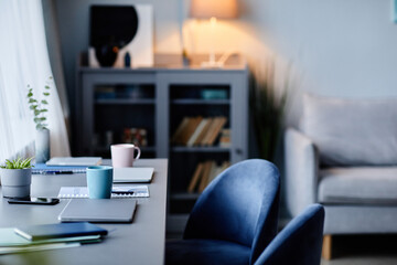 Background image of modern home interior with workplace in dark blue colors, copy space