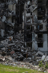 Fototapeta na wymiar War in Ukraine 2022. Destroyed, bombed and burned residential building after Russian missiles in Kharkiv Ukraine. Famous building on Natalia Uzhviy street. Russian attack. 