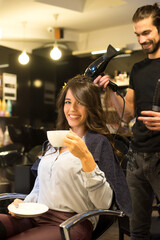 Young woman getting new hairstyle from hairdresser in the modern hair salon