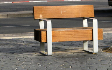 Bench for rest in the city park on the seashore.