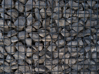 a wall of stones inside the iron barrier