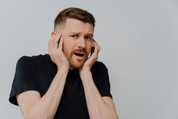 Shocked scared man looking at camera with frightened face expression