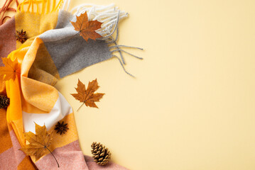 Autumn aesthetic concept. Top view photo of yellow maple leaves anise pine cones and scarf on...