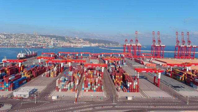 Aerial view over Haifa port with cranes and containers, israel 
Drone view over cranes and cargo containers, Haifa,Israel,July,27,2022
