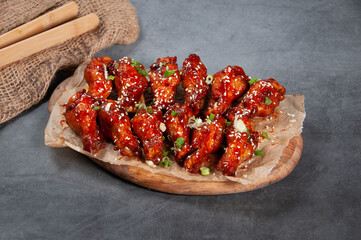 chicken Drumlets 12 piece isolated on wooden board on grey background side view of fastfood